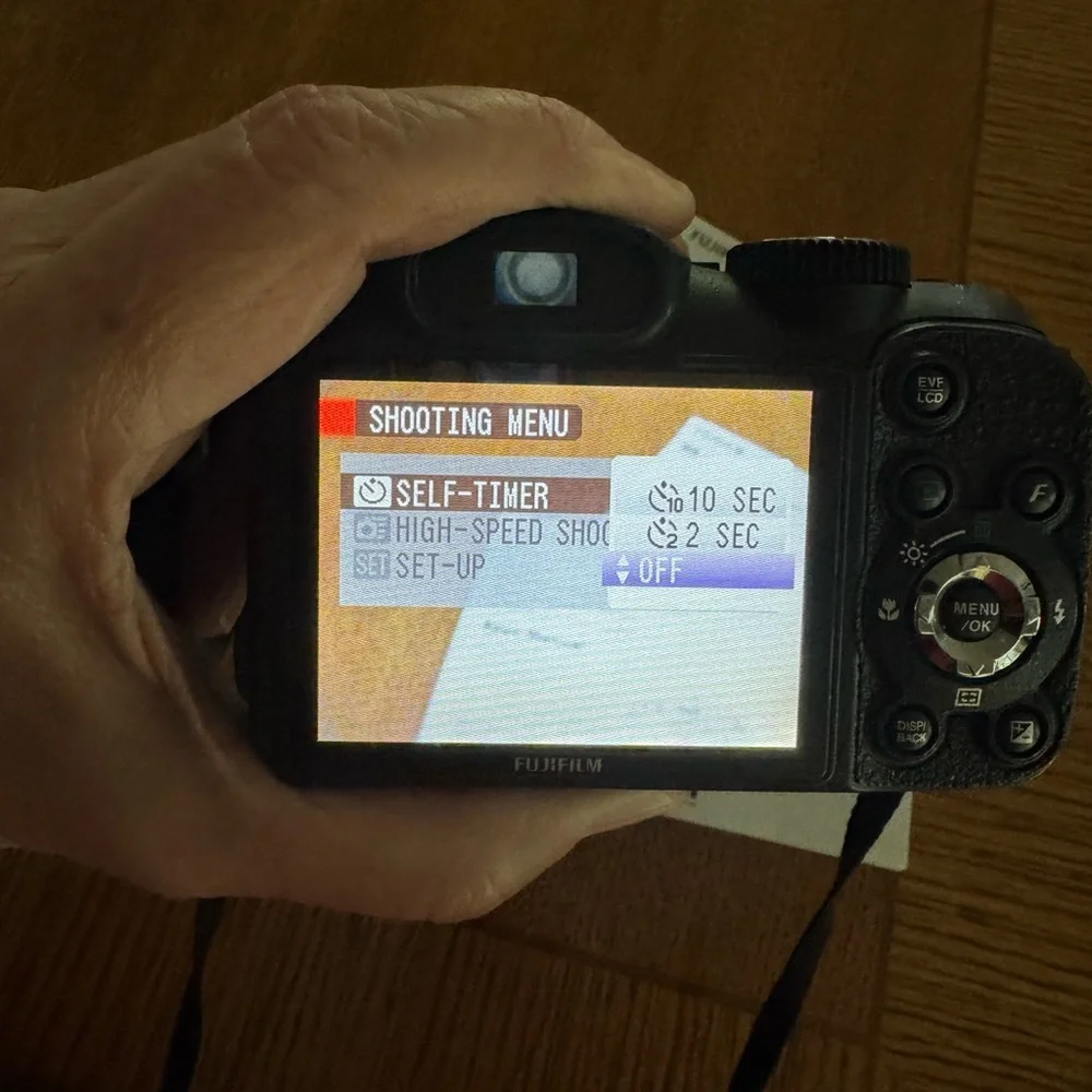 Fujifilm Black Digital Model S2550HD Camera with Zoom Lens and Ergonomic Grip.